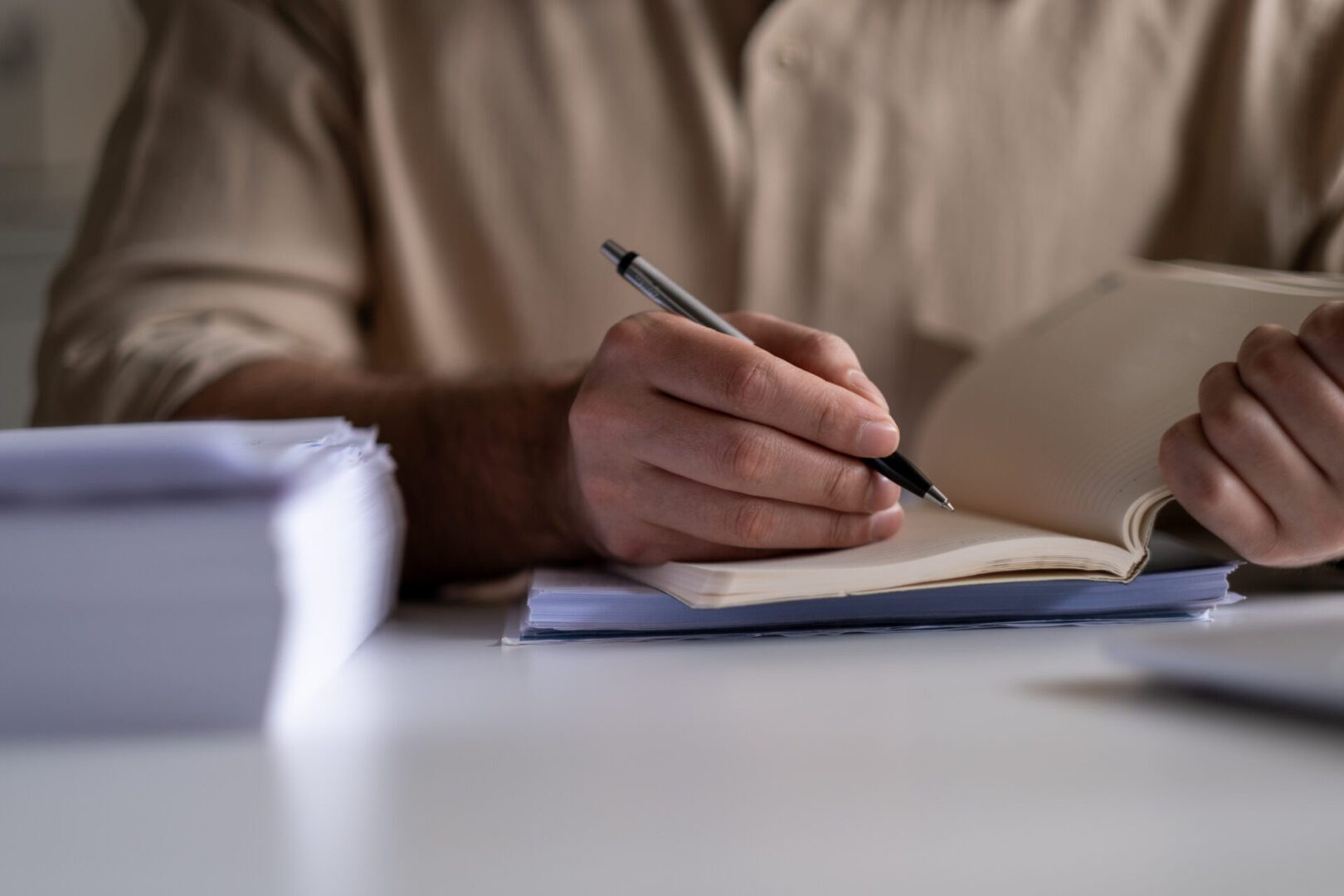 Person taking notes with pen